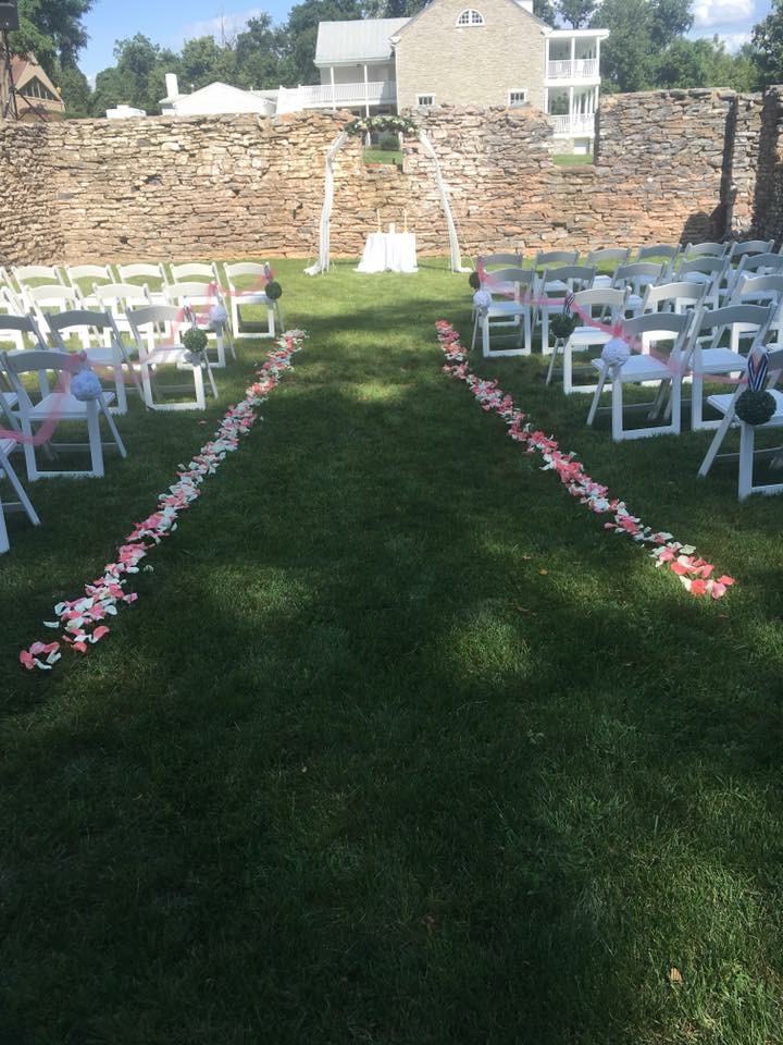 Flower petals lining a ceremony aisle
