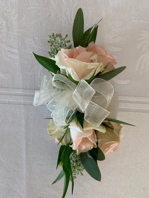 Light pink rose corsage with ribbon