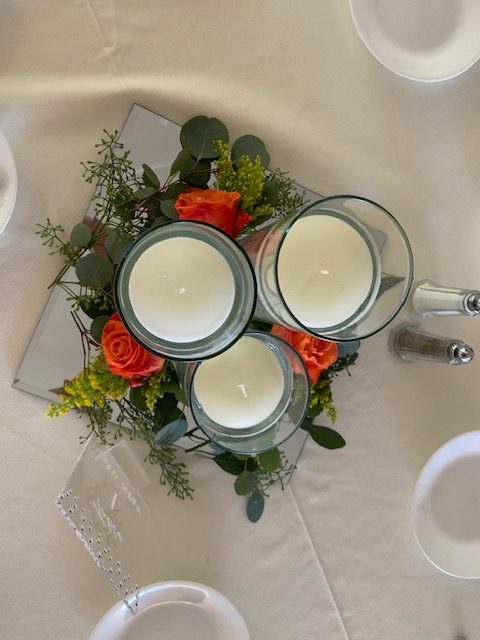 Orange rose and greenery centerpiece