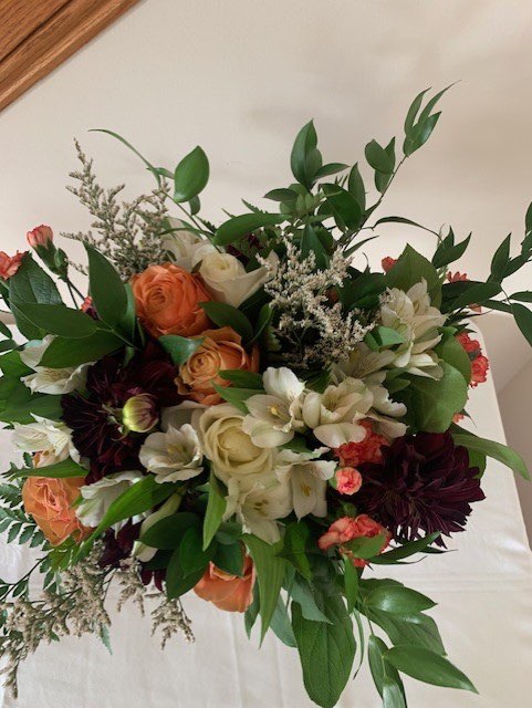 Orange, burgundy, and white garden-style bouquet