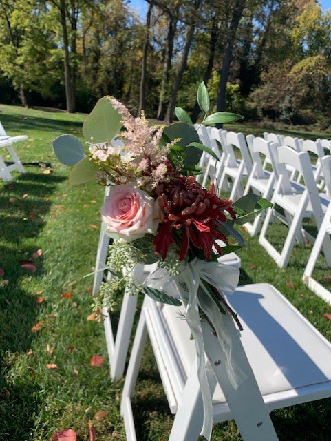 Pink rose and burgundy mum aisle chair arrangement