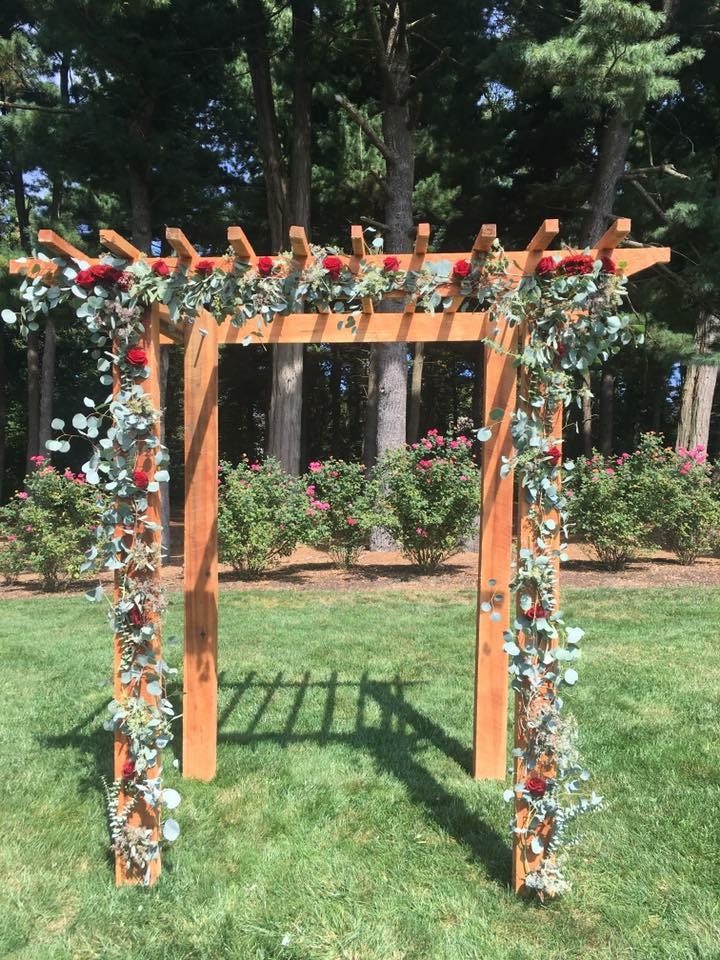 Red rose and greenery ceremony arbor