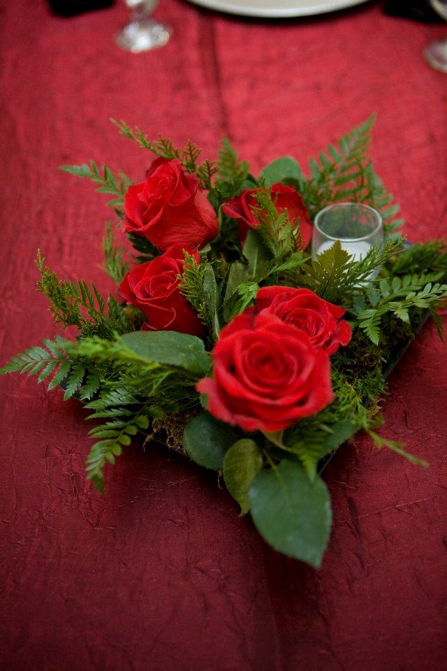 Red rose and greens centerpiece