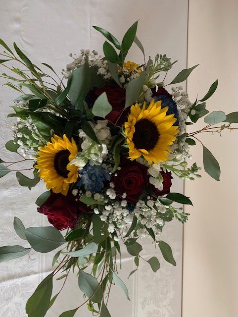 Sunflower, burgundy rose, and greenery bridal bouquet