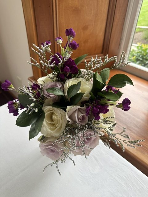 White and purple rose, astilbe, and mini carnation bouquet