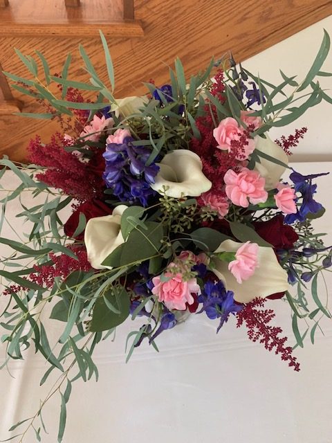 White calla lily, pink mini carnation, and burgundy astilbe bouquet