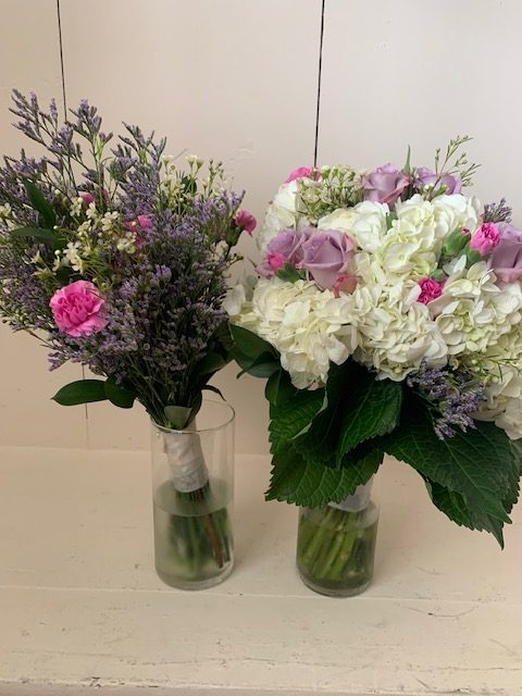 White hydrangea, purple rose, and pink mini carnation bouquet