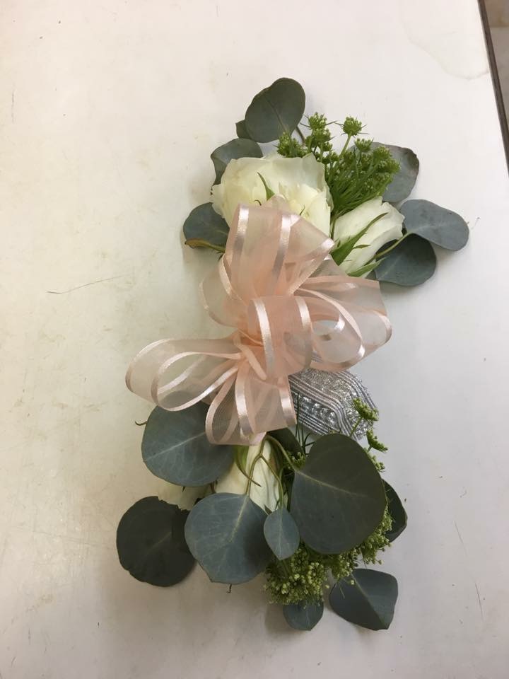 White rose wrist corsage with greenery
