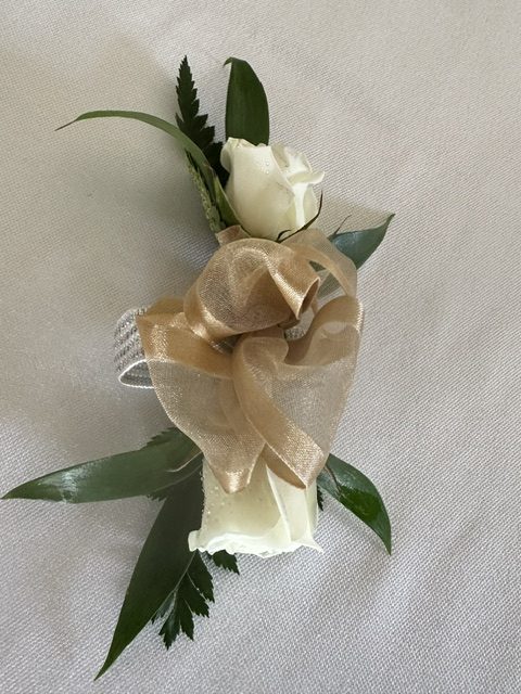 White sweetheart rose corsage with gold ribbon